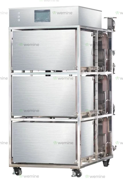 Stacked metallic immersion cooling tanks for ASIC miners with visible tubing and digital display, mounted on casters for mobility, branded with the 'wemine' logo.
