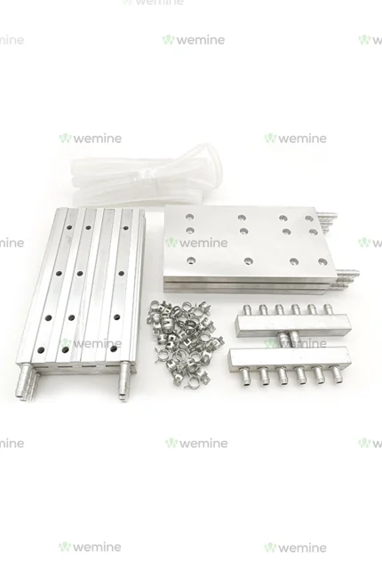 Assorted WeMine machine parts including aluminum extrusions, connector blocks, nuts, and cables, neatly arrayed on a white surface, highlighting the brand's dedication to precision engineering.