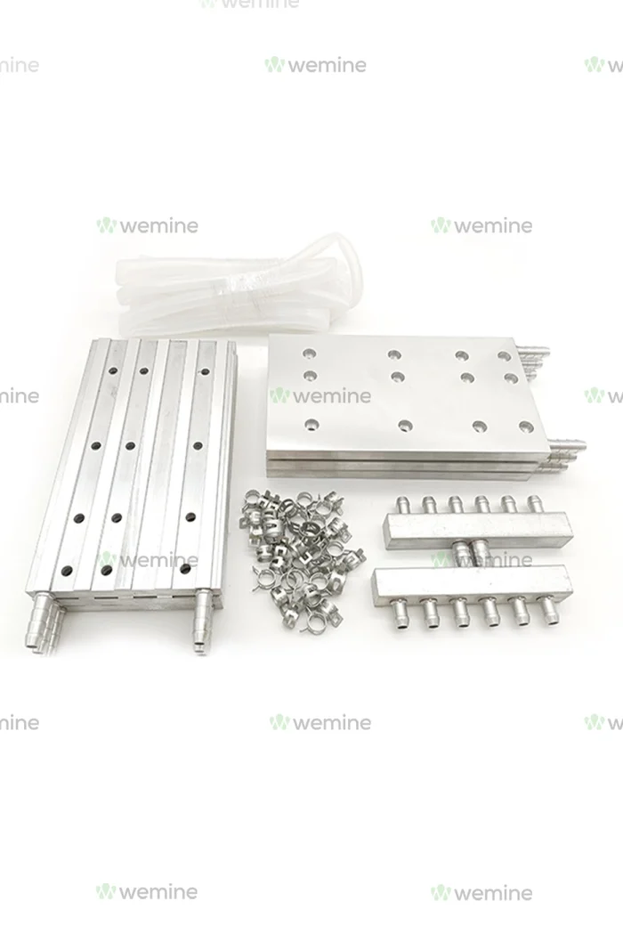 Assorted WeMine machine parts including aluminum extrusions, connector blocks, nuts, and cables, neatly arrayed on a white surface, highlighting the brand's dedication to precision engineering.